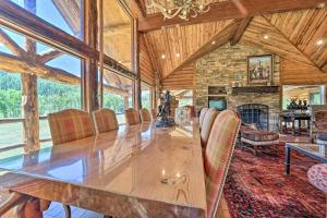 a dining room with a large wooden table and a fireplace at Fish Creek Ranch in Dolores Hot Tub and Game Room in Dolores