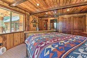a bedroom with a bed in a wooden cabin at Fish Creek Ranch in Dolores Hot Tub and Game Room in Dolores