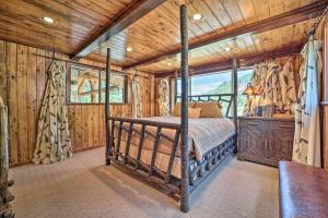 a bedroom with a bed in a room with wooden walls at Fish Creek Ranch in Dolores Hot Tub and Game Room in Dolores