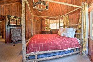 a bedroom with a bed in a room with wooden walls at Fish Creek Ranch in Dolores Hot Tub and Game Room in Dolores