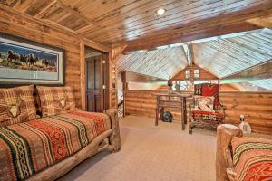 a log cabin bedroom with two beds and a table at Fish Creek Ranch in Dolores Hot Tub and Game Room in Dolores