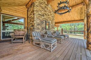 a porch of a cabin with chairs and a chandelier at Fish Creek Ranch in Dolores Hot Tub and Game Room in Dolores