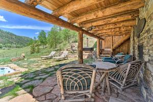 a patio of a cabin with a table and chairs at Fish Creek Ranch in Dolores Hot Tub and Game Room in Dolores