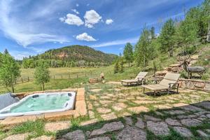 a backyard with a hot tub and two chairs at Fish Creek Ranch in Dolores Hot Tub and Game Room in Dolores