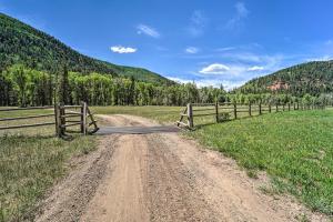 a dirt road in a field with a fence at Fish Creek Ranch in Dolores Hot Tub and Game Room in Dolores