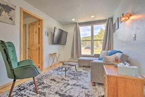 a living room with a couch and a tv at Modern Mountain-View Condo at Big Sky Resort! in Big Sky