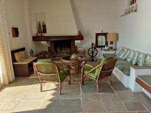 a living room with a couch and a table and chairs at Lito's dream villa by the sea! in Amaliapoli