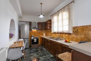 a kitchen with a sink and a counter top at A&S Seaside House in Lixouri