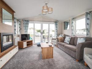a living room with a couch and a tv at 205 The Meadows in Newquay