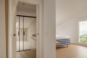 a bedroom with a walk in closet with a mirror at Hotel Boutique Berazadi Berri in Zarautz
