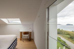 a bedroom with a bed and a desk and a window at Hotel Boutique Berazadi Berri in Zarautz +37 photos