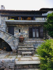 a stone house with stairs in front of it at Lito's dream villa by the sea! in Amaliápoli
