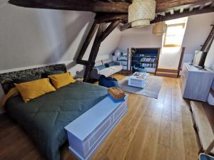 a living room with a green couch in a room at La ferme de la Terve in Bruailles
