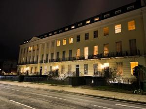 a large white building on a street at night at Pittville Studios - By Suitely in Cheltenham