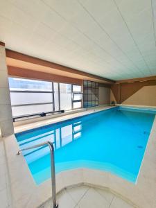 a large swimming pool with a large window at Hotel Brotnjo in Čitluk