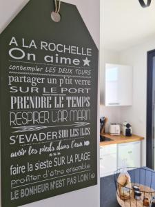 a sign on a wall in a kitchen at Location LA BELLE - LA ROCHELLE B in La Rochelle