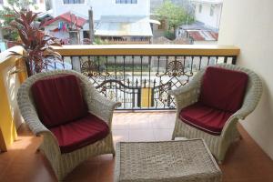 two chairs and a table on a balcony at Guesthouse Cavite in Dasmariñas
