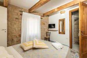 a bedroom with a bed with two pillows on it at Bed and Terrace Caterina in Baunei +50 photos