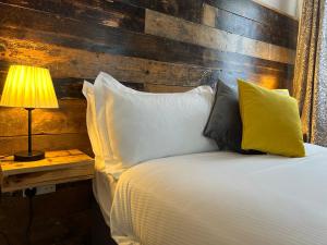 a bedroom with a bed with a wooden headboard at The Brookmill in London