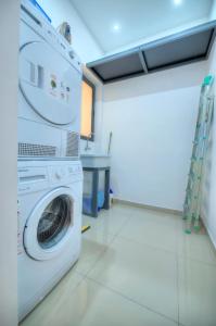 a laundry room with a washer and dryer at Spacious and beautifully furnished 3 bedrooms/3bathrooms apartment with 2 balconies WVID1-1 in Il-Gżira