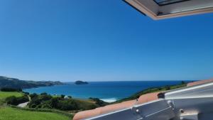 a view of the ocean from the balcony of a house at Hotel Boutique Berazadi Berri in Zarautz