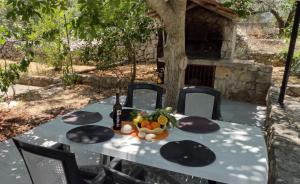 una mesa con una botella de vino y fruta. en apartmani ANITA, Korčula, en Korčula