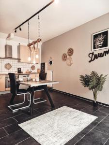 a dining room with a table and a kitchen at Holiday Home Alessia in Bollendorf