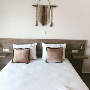 A bed or beds in a room at elenamou seaview rooms