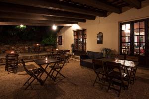 Un restaurante con mesas y sillas en una sala. en Auberge Ferayola, en Galeria