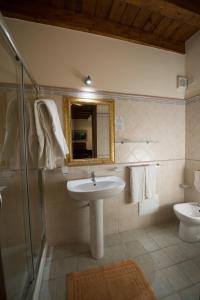 a bathroom with a sink and a shower and a mirror at Hotel Aliai in Sciacca