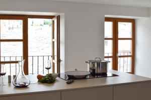 a kitchen with a counter with a stove and a window at La Casa del Mare - Bastia centre vue Mer et citadelle in Bastia