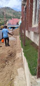 a man standing next to a fence at Arihanth Inn in Vellore