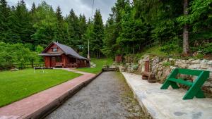 a log cabin in the middle of a yard at Chalet Woody in Stara Sušica