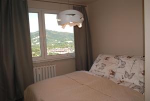 a bedroom with a bed and a large window at Apartament Manhatan 4 in Ustroń