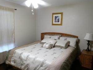 a bedroom with a bed with two pillows on it at WelcomeHomeLakeland, FL in Lakeland