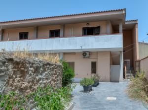 a house with a fence in front of it at IzzHome Escape 2 in Villa San Pietro
