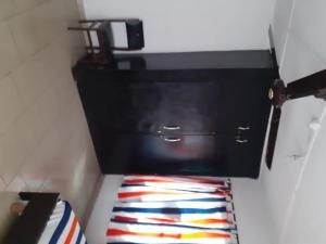 a bathroom with a black toilet and a colorful towel at Impeccable 3-Bed Apartment Located in Lagos in Lagos