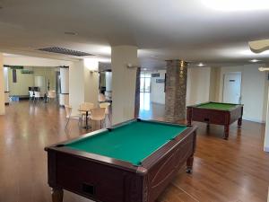 a pool table in the middle of a room at Le Village des Isles in Taglio-Isolaccio