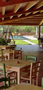 a wooden table and chairs under a wooden ceiling at Valle Lumia in Letojanni