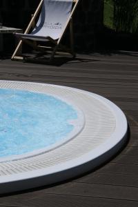 a deckchair and a chair next to a swimming pool at Willa Brygida Spa in Kudowa-Zdrój