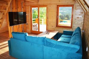 a living room with a blue couch and a table at Peace of mind in Visoko