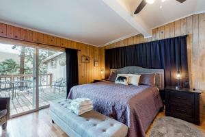a bedroom with a bed and a balcony at Bear Creek Cottage in Joseph