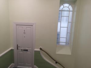 a hallway with a door and a window at Penthouse Flat with River View, 1C in Great Yarmouth