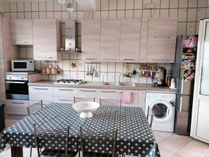 a kitchen with a table with a polka dot table cloth at Le stanze di Anna in Capaci