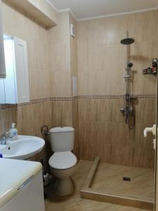 a bathroom with a toilet and a sink and a shower at Belisima 204 B in Ravda