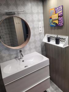 ein Badezimmer mit einem weißen Waschbecken und einem Spiegel in der Unterkunft Tobozka Vendégház in Noszvaj