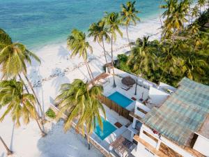 an aerial view of a resort on a beach with palm trees at Coco Rise Villas - by Hostly in Bwejuu
