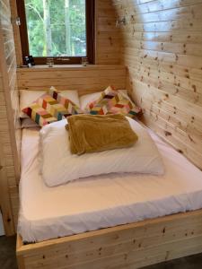 two beds in a log cabin with a window at Wilding on a Whim in West Linton