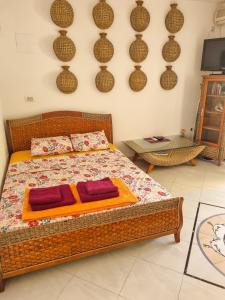 a bedroom with a bed with two pillows on it at Apartments Rales in Sveti Stefan