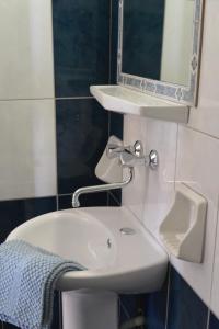 a bathroom with a sink and a mirror at Hotel Hariklia in Agia Galini